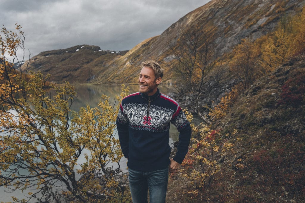 Man in sweater by lake